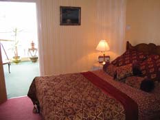 Luxurious bed within the Lamp Room Suite